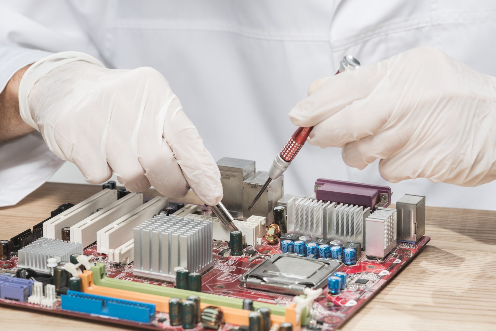 technician-wearing-gloves-working-on-computer-motherboard.jpg
